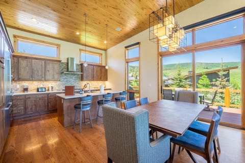 Open concept kitchen, dining and living areas all with mountain views