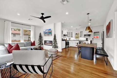 The living room, kitchen, and dining area with an open concept are bathed in abundant natural light.