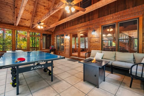 Game on and cozy vibes! Enjoy sunny days and fun nights on the screened porch - where fun meets relaxation at our mountain retreat! 🏔️🏓🔥 The back screened porch is a favorite hangout with ping pong, a picnic table and seasonal propane fire pit.