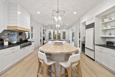 Bar seating for four, a double oven, and gas range.