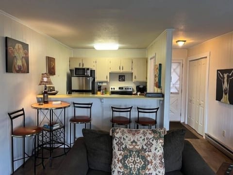 Cozy kitchen with a breakfast bar and open living area for relaxing.