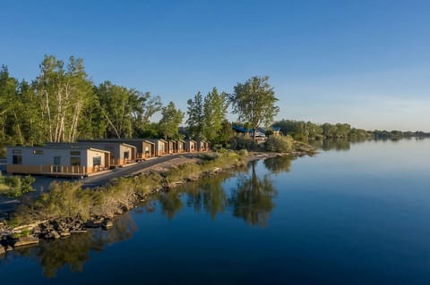 Wake up to serene waterfront cabins and endless blue skies.