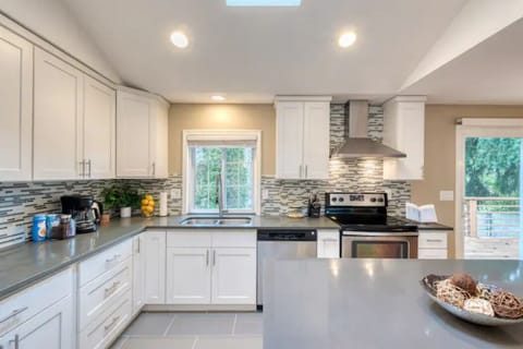 Newer, modern kitchen with new quartz counter top and stainless steel appliances