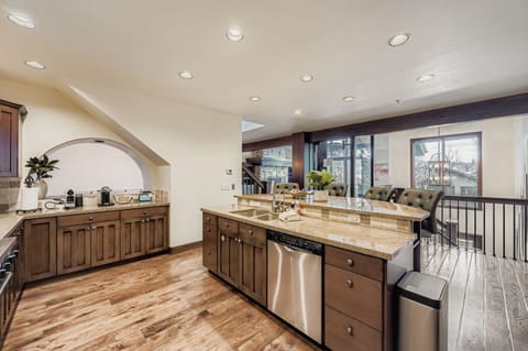 Your spacious kitchen features granite countertops, stainless steel appliances, and an open layout perfect for preparing meals while staying connected with your group.