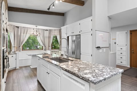 Your gourmet kitchen features granite countertops, stainless steel appliances, and garden views for memorable meal preparation.