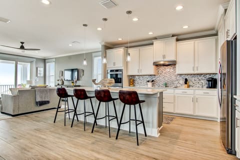 - Host with ease in this open concept kitchen with bar seating, pendant lights, & modern appliances
- Spacious layout connects seamlessly to the living room for cooking & conversation
- Elegant finishes & plenty of counter space for every craving