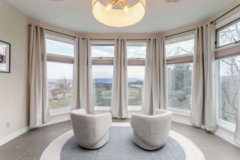 Wake up to bright natural light and serene views in the primary bedroom.