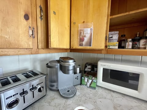 Pantry stocked with Keurig coffee pods, olive oil, salt, pepper, sugar etc 
