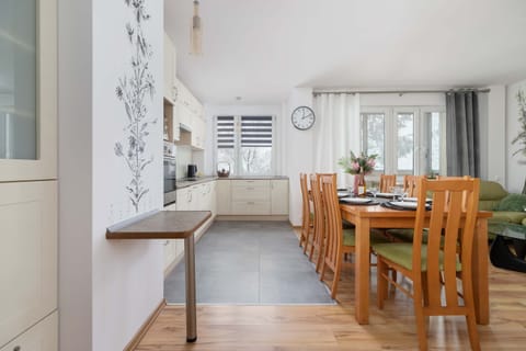 A dining area adjacent to a functional kitchen with a minimalist design.
