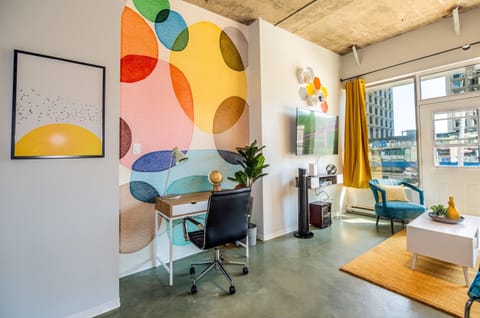 Bright and open living room with vibrant modern decor, featuring a sofa bed for an extra guest or couple