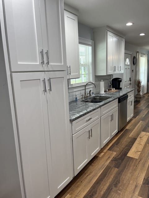Plenty of pantry space with cooking supplies, bowls, dishes and silverware.