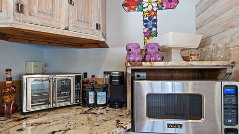 Coffee station with a Keurig coffee machine, toaster oven, and a microwave.