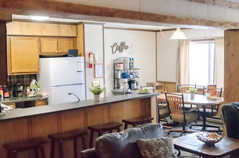 Open kitchen and dining area overlooking the mountains, along with dining table and bar seating, stocked coffee bar, fridge, oven/stove, toaster oven, air fryer, waffle maker & s'mores maker.