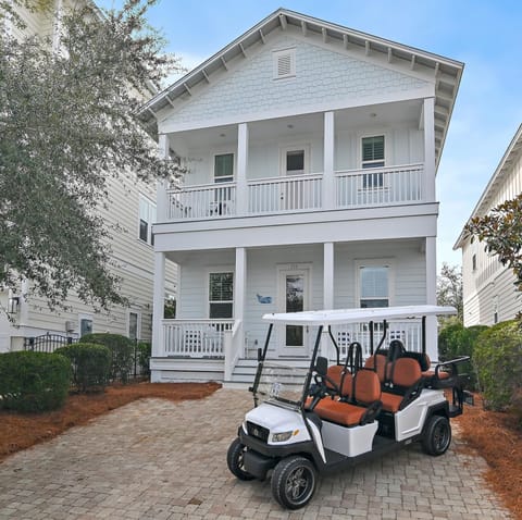 Spacious front porch and driveway with 6-seat golf cart