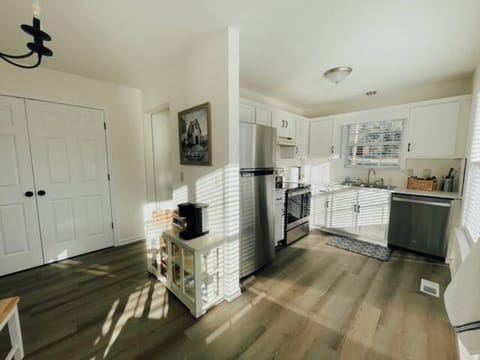 Airy, eat-in kitchen with a coffee cart.