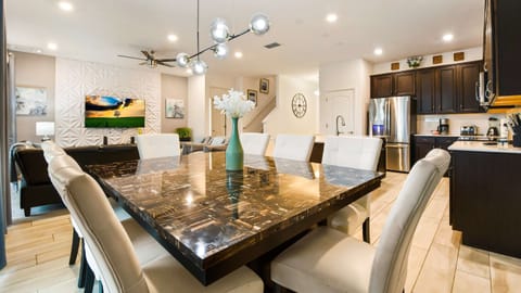 Stylish open-concept space with a sleek dining area, modern kitchen, and cozy lounge.