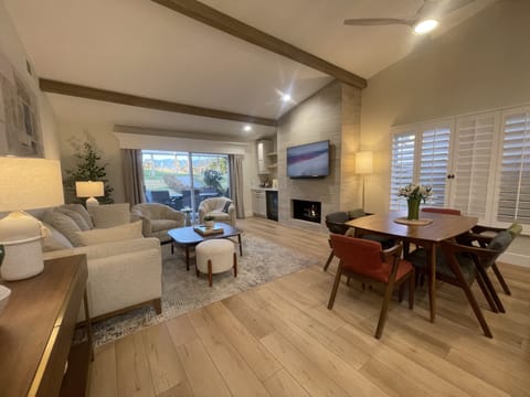 Large living room with sliders to patio.  Gas fireplace, Frame TV, wine fridge.