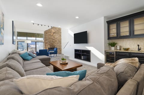 Oversized sofa with wet bar and bev fridge.