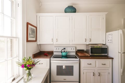 Stove, Microwave and Refrigerator in Full Kitchen