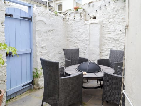 Enclosed courtyard with sitting-out area and firepit | Anchor Cottage, Instow, near Bideford