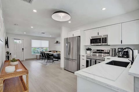 Fully-stocked gourmet kitchen is in the center of the home, right off of the dining room.