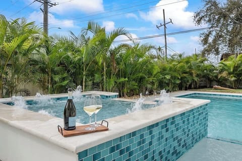 BRAND NEW!!  Tropical pool with a sun shelf, and a hot tub surrounded by lush landscaping.  Welcome home - relax and have fun!