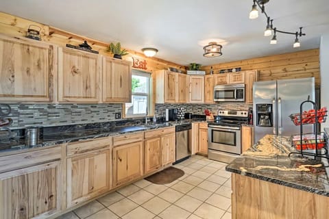 Full kitchen with modern appliances, coffee makers, and stocked essentials.