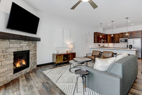 This Stunning Living room Has A 55" HD TV Mounted Above The Custom Stone Fireplace Below