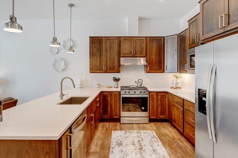 Fully Stocked Kitchen With White Granite Countertops Accenting The Gorgeous Custom Wood Cabinetry Hanging Below And Above