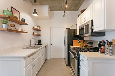 Full kitchen with gas range and oven, refrigerator and freezer, and dishwasher