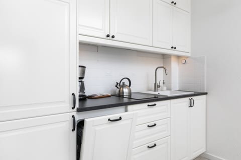 Another view of the kitchen, focusing on the cabinets and sink.
