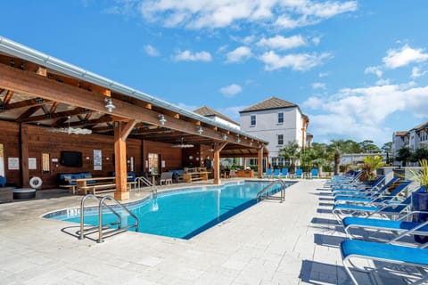 90' heated pool + lounge seating + 5 large screen TVs under covered pavilion with additional dining and seating