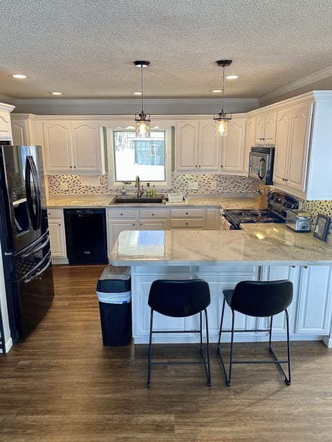 Plenty of kitchen counter space with barstools. Dishwasher in the kitchen!