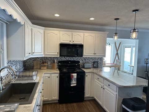 Roomy kitchen with lots of counter space & storage. Stocked with essentials