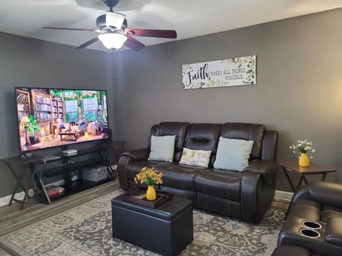 Comfortable leather sofas with 75 inches TV, plus XUMO 4K UHD streaming device.