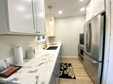 Nice Kitchen with granite countertops, stainless steel fridge and oven. 