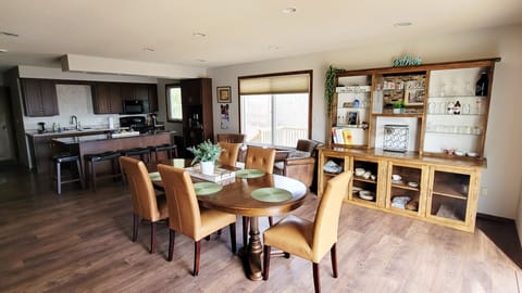 Dining area connected to the kitchen seats 8 at the table and 4 at the island.