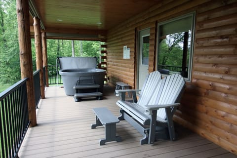 Large front porch, 4 person hot tub, glider.