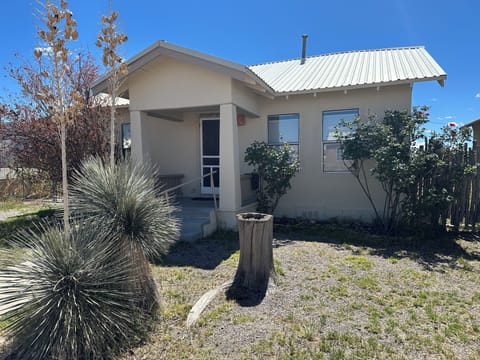 Front of House with large Pomegranite bush, roses and yuccas