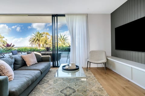 Light filled living room with expansive views and 75" Smart TV
