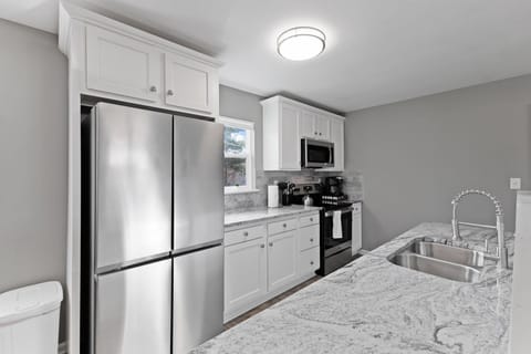 Modern kitchen appliances include an electric range