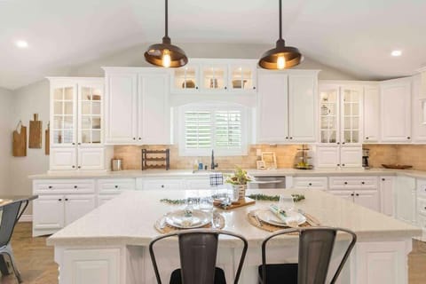 Stylish kitchen island with sleek pendant lights hanging above.