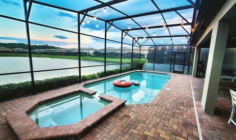 Enjoy a Refreshing Dip in Your Own Private Pool & Hot Tub Under the Lanai with a relaxing view of the pond. Child barrier gate can be put up.