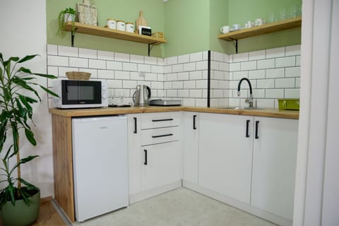 Kitchen with an induction stove, electric kettle, and a microwave