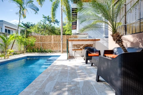 Backyard space with pool and seating for guests