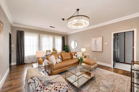 A bright, open living room with a leather sectional and chaise sofa, offering a perfect blend of comfort and elegance for ultimate relaxation.