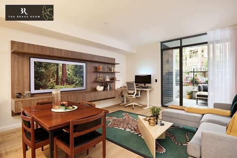 Our spacious open plan living room, boasts a beautiful mid century look with clean lines, incorporating wood and leather finishes. The space offers a full dining table seating for four. There is also a fully equipped plug and play workstation. 