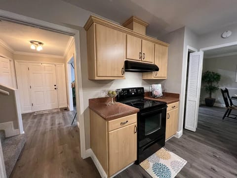 Kitchen photo with stove, toaster, blender, starter spices, and pantry.