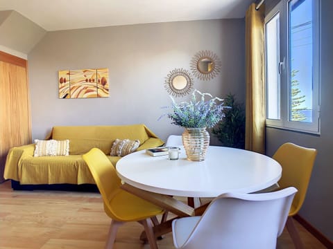 Charming Porto Moniz home adorned in lovely yellow tones. #cozy #sideoceanview #sofa #livingroom