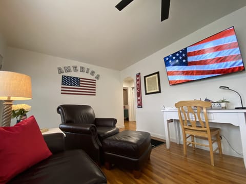 Inviting Living Room includes 2 Brown Leather Chairs with Ottomans, Couch& 65TV!
